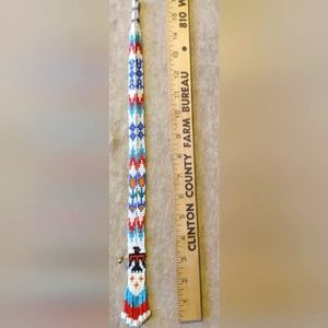Native American beaded necklace with eagle and arrows .